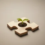 Wooden puzzle piece with a green sprout growing from soil at its center on a soft, neutral background.