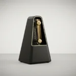 Minimalist black metronome with brass pendulum mid-swing on a soft gray background, symbolizing steady outreach cadence.