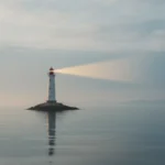 Lighthouse in soft fog casts a warm beam across calm water, symbolizing clear guidance and recovery.