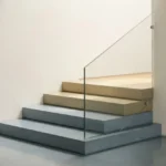 Minimalist staircase rising from slate blue to gold, symbolizing a transparent and trusted path to higher rates.